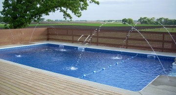 Backyard pool designs with fountain and wooden deck