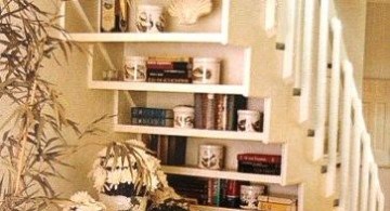 Bookshelf stuffed and decorated under the staircase