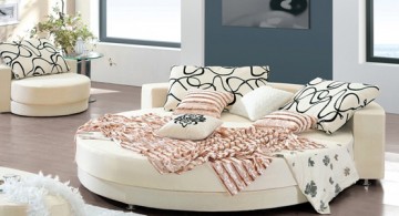 all white circular bed with chic pattern sheets