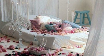 bedroom decoration for valentines day with flower petals and many cushions