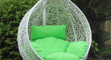 bedroom swing chair in white wicker and green cushions