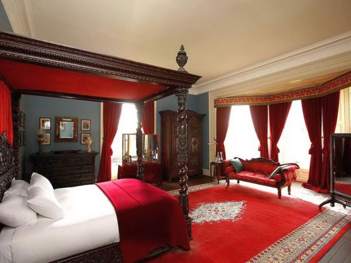 classy red and black bedroom with canopied bed