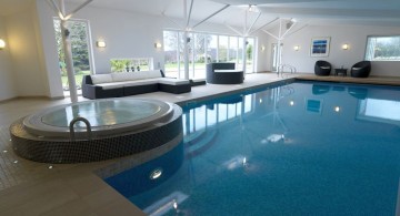 indoor swimming pool with glass doors and jacuzzi