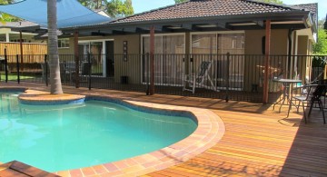 kidney shaped swimming pools on wood deck