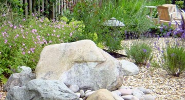 landscaping designs with big rocks and white fences