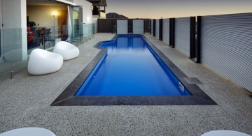 lap pool designs with stone deck and contemporary furnitures