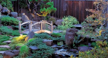 lush japanese style backyard with small bridge