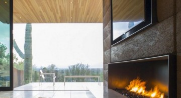 modern fireplace designs with glass outlooking the garden