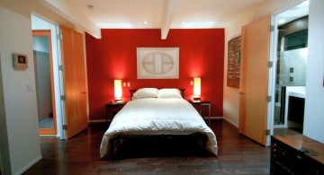 modern mens bedroom with red accent wall
