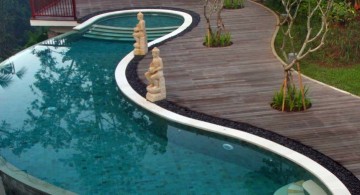overflow kidney shaped swimming pools with wooden pathway