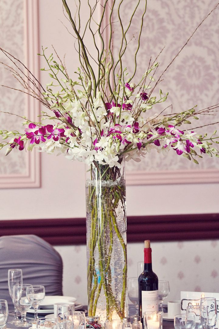 tall vase with branches and orchids