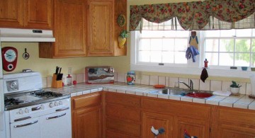 vintage and retro kitchen design with rustic cabinets and flower curtains