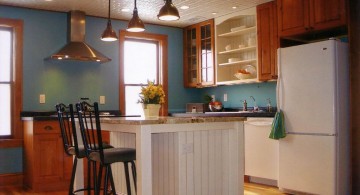 white kitchen island with sink in blue walled kitchen