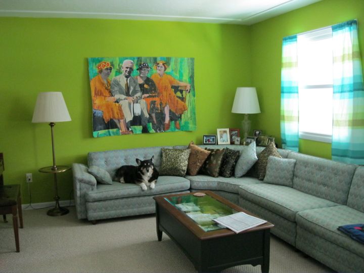 Grey and green living room with L shaped sofa and green wall