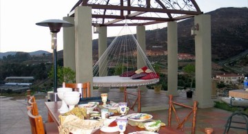 Outdoor swinging beds next to dining table