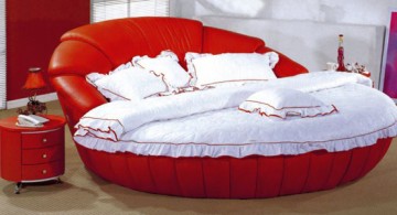 Striking red round bed frame design topped with chic white bedding