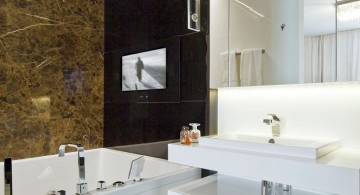brown bathrooms with built in TV on the wall