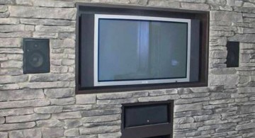 built in TV on textured stone wall