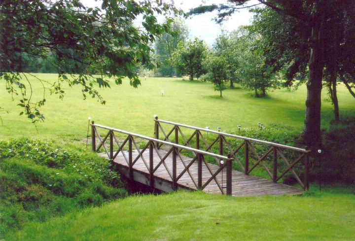 flat DIY garden bridge with steel railings