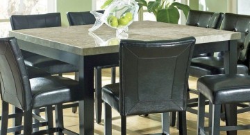 granite dining room table with black chairs