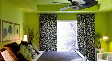 lime green bedroom with black curtain and leaf shaped fan