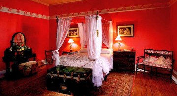 luxurious red bedroom walls with canopy bed