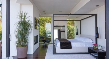 minimalist modern four poster bed on wide bedroom