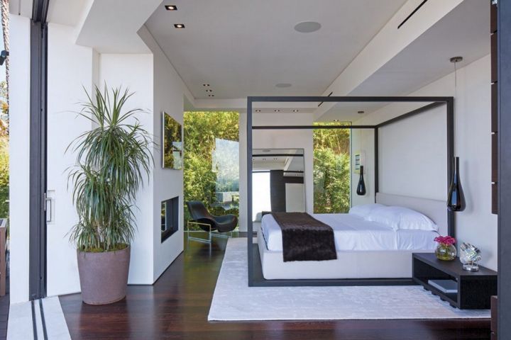 minimalist modern four poster bed on wide bedroom