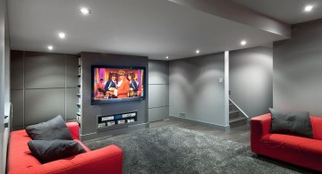 modern basement with grey walls and red sofa