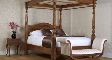 modern four poster bed with a settee