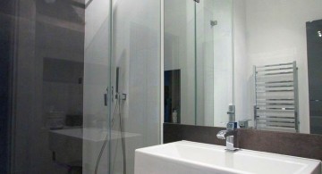 modern glass shower with track lighting