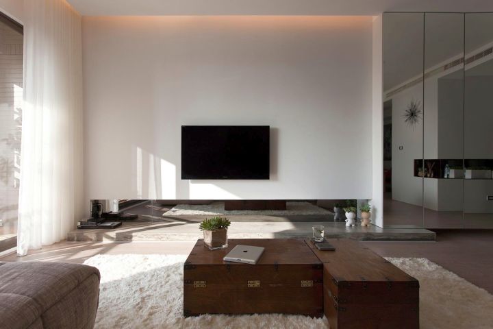 modern minimalist living room with mirror wall panel