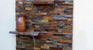 modern water features built in wall stone with floating shelf