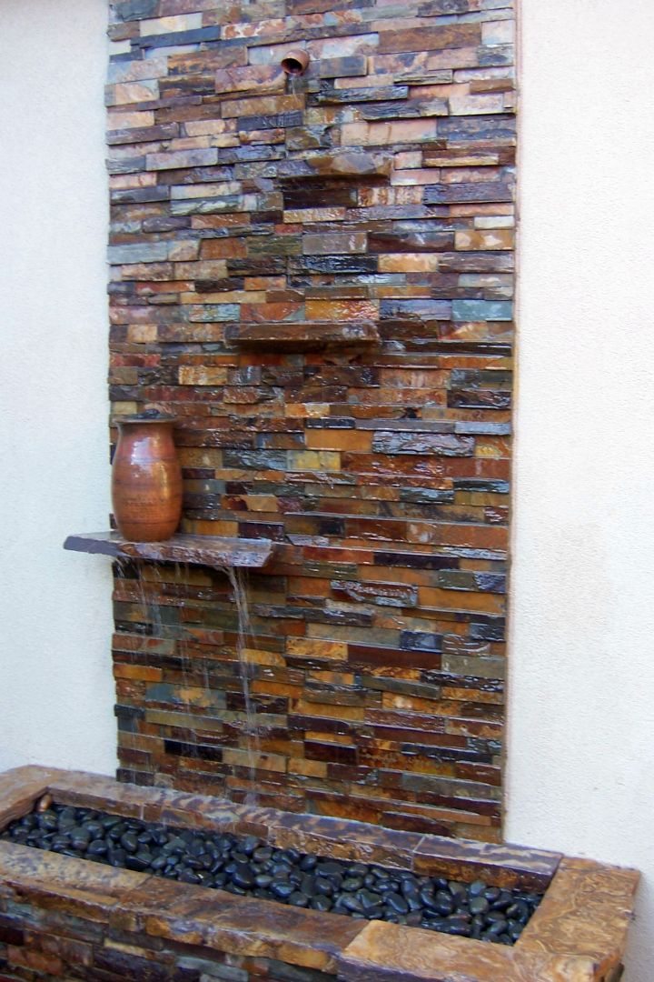 modern water features built in wall stone with floating shelf