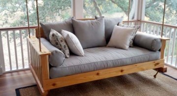 outdoor swinging beds in nice grey and brown accent installed on airy balcony on second floor