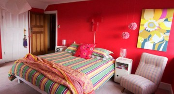 red bedroom walls with colorful bedding