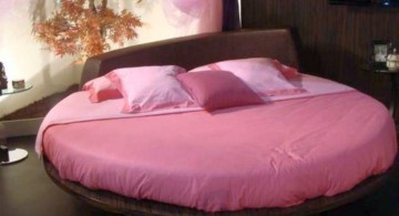 round bed frame with pink bedding