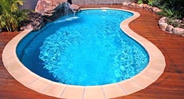 small kidney shape pool with wooden deck