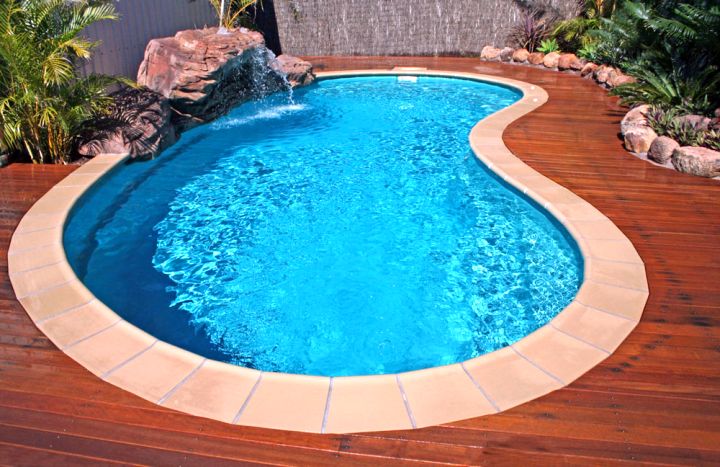 small kidney shape pool with wooden deck