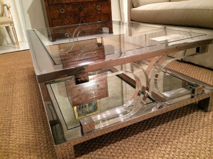 square lucite coffee table with X stand and lined with steel