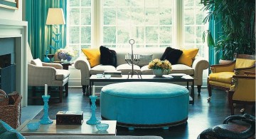 turquoise living room decor ottoman sofa, curtains, and small candelabra