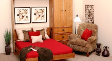 wall bed couch with red bedding and wall decor