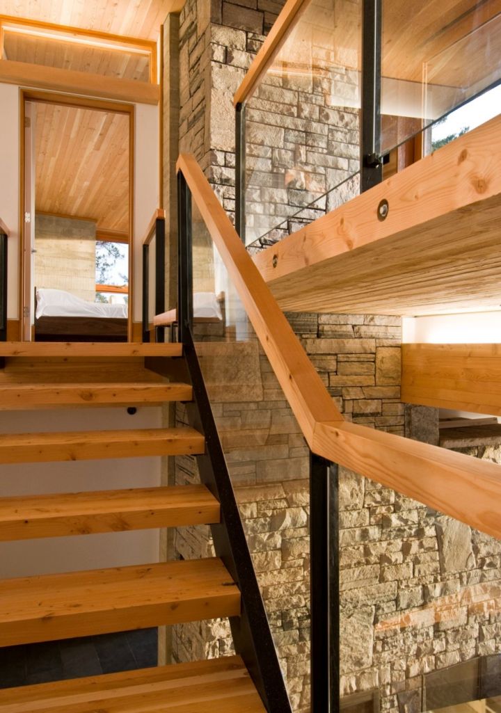 wood staircase with patterned glass railing