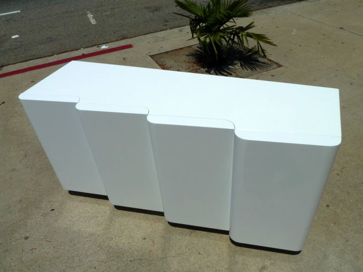 contemporary waved white lacquer credenza