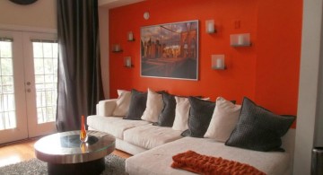 minimalist red wall accent with L shaped sofa