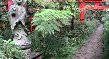 oriental garden design with statue and red gate