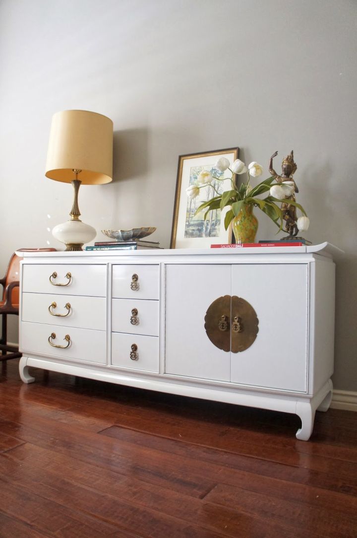white lacquer credenza with chinese coin accent