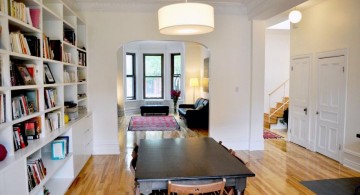 built in bookshelves in dining room with wooden floor