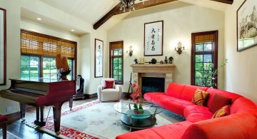 cathedral ceiling living room with red half moon sofa and a piano