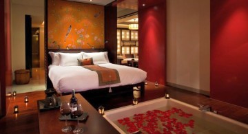 modern asian bedroom with floor tub and flower petals